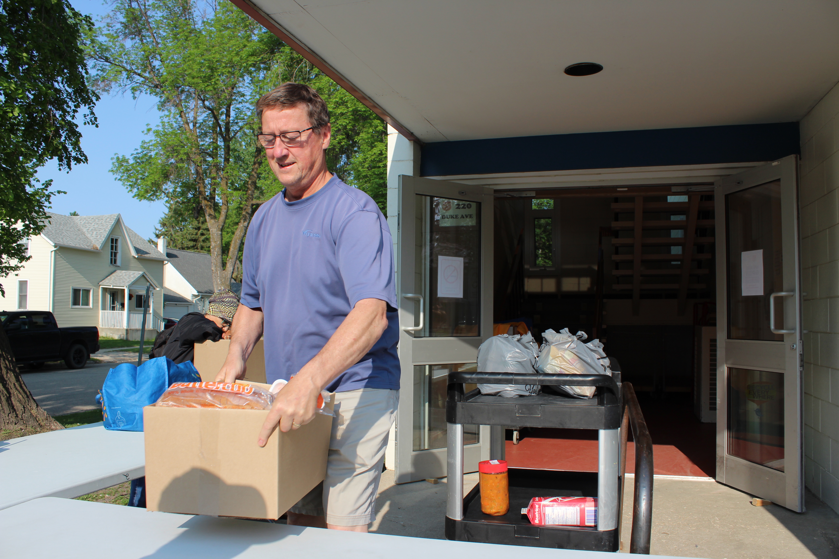 Man putting box of food on table